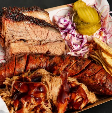 Southwest Barbecue smoked meat platter with brisket, sausage, pulled meat, slaw and pickles