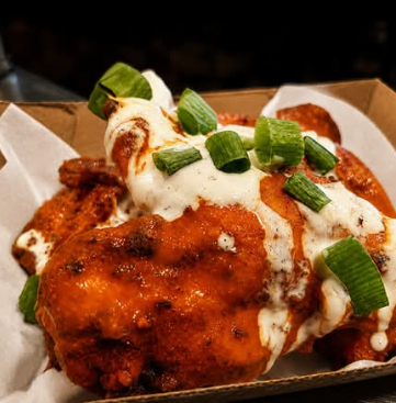 Buffalo wings topped with ranch and spring onion